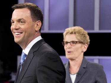 Ontario PC leader Tim Hudak, left, laughs next to Ontario Premier Kathleen Wynne, right, after taking part in the live leaders debate at CBC during the Ontario election in Toronto on Tuesday, June 3, 2014.