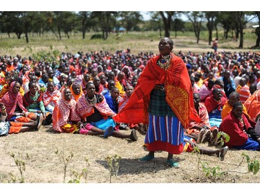 A woman speaks as Kenyan Maasai women gather for a meeting dedicated to the practice of female genital mutilation (FGM) in which several participants voiced opposition to a ban currently in place, on June 12, 2014, in Enkorika, Kajiado, 75km from Nairobi. Some women of the semi-nomadic Maasai community expressed the view that uncircumcised girls are no longer getting married and are promiscous, which they said was against their traditional culture. FGM is perceived by some of the more traditional women of the Maasai community as bringing honour to a girl and to her family, making girls more eligible for marriage and raising the social status of their familes. The Maasai have held to the custom in the face of widespread criticism by Kenyan society and the international community, and despite criminalisation of the practice by the Kenyan government in 2002. The Maasai ceremonial ritual accompanying FGM marks the coming of age of a girl, when she sheds the last vestiges of childhood and joins womankind. It is traditionally performed between the ages of 12 and 14 and is part of the traditional rites of passage for girls, in order for them to be considered adults in their community.