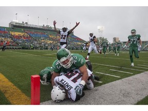 Saskatchewan Roughriders linebacker Kevin Regimbald takes down Ottawa Redblacks wide receiver Jamill Smitth during first half of CFL pre-season football action in Regina, Sask., Saturday.