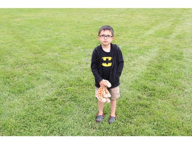 Kieran Murphy, 5, and his giraffe, Giraffe, at the CHEO Teddy Bear pinic at Rideau Hall on Saturday.