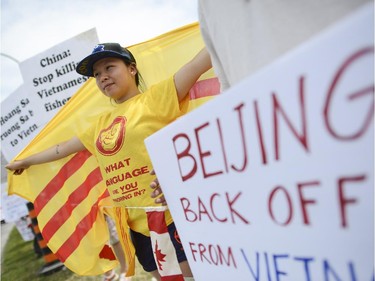 Local spoken word artist and member of Vietnamese community, Kim Nguyen protests in front of Chinese Embassy along with community members from Ottawa, Toronto and Montreal on Sunday, June 8, 2014. The Vietnamese community members are protesting against the Chinese government's aggressive territorial policy toward Vietnam, and against the weak response as well as the suppression of patriotic demonstrations by Vietnamese citizens on the part of the Vietnamese government. (James Park / Ottawa Citizen)