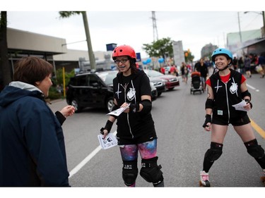 Marina Belvin of the Rideau Valley Roller Girls' Prime Sinisters roller girl team makes her way along Richmond rd. to promote their next match, in Westboro in Ottawa, during Westfest on Saturday, June 14, 2014.