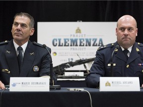 Mario Desmarais, left, with the Montreal Police Department and Michel Arcand with the RCMP speak to reporters during a news conference at RCMP headquarters in Montreal, Thursday, June 12.