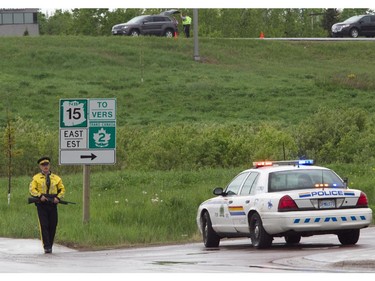 MONCTON, N.B.: June 5, 2014 -- An R.C.M.P. officer stands by a roadblock on on Saint George Blvd. during the manhunt for Justin Bourque in Moncton, New Brunswick, on Wednesday, June 5, 2014. The man is suspected of killing three Royal Canadian Mounted Police officers. (John Kenney / THE GAZETTE) ORG XMIT: POS1406051426227047