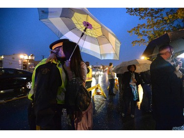 Moncton resident Gretchen Mejoranda hugs RCMP officer Angie Hawryluk at a candlelight vigil outside RCMP headquarters in Moncton, N.B., on Friday, June 6, 2014. RCMP say a man suspected in the shooting deaths of three Mounties and the wounding of two others in Moncton was unarmed at the time of his arrest early Friday and was taken into custody without incident.