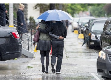 Mourners brave the rain as they arrive at St. Anthony's Church in Ottawa before the funeral of Brandon Volpi on Friday, June 13, 2014. Volpi, a student at St. Patrick's High School was killed in a stabbing during his prom night in downtown Ottawa.