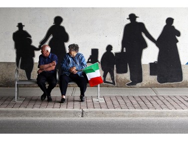 Mr. and Mrs. Cacciotti watch as Italian made cars make their way along Preston St. in Ottawa's Little Italy, during Italian Festival on Saturday, June 14, 2014.