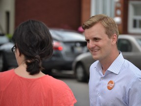 NDP candidate Joe Cressy talks with a voter while canvassing in Trinity-Spadina. Despite spending heavy political capital in the riding, the NDP candidate lost in Monday's byelection.