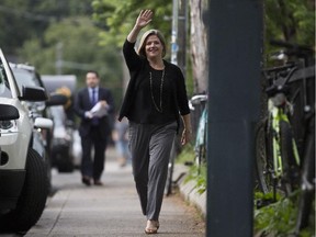NDP Leader Andrea Horwath waves to volunteers in the early hours of election day in Toronto's Kensington Market Thursday.