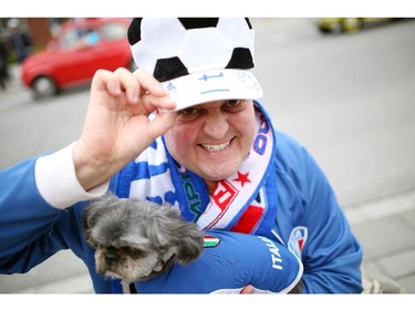 Nick Arnone and his dog Nove are dressed with country pride on Preston St. in Ottawa's Little Italy, during Italian Festival on Saturday, June 14, 2014.