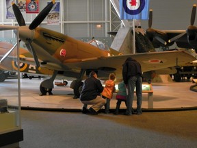 Visitors look at the Supermarine Spitfire at the Canada Aviation and Space Museum.