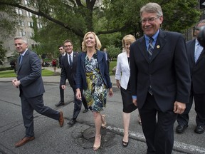 Christine Elliott, centre, walks across University Avenue toward Queen's Park with supporters after announcing her intention to run for the Ontario PC leadership during a press conference in Toronto on June 25.