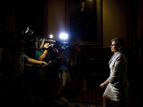 Ontario Premier Kathleen Wynne, right, is followed by media as she makes her way to her office after winning a Liberal majority government at Queen's Park in Toronto on Friday, June 13, 2014. Wynne became the first woman elected Premier of Ontario. THE CANADIAN PRESS/Nathan Denette