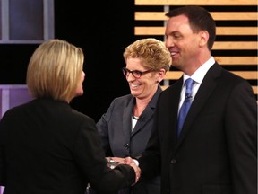 Ontario NDP leader Andrea Horwath, Ontario Premier Kathleen Wynne, centre, and Ontario Progressive Conservative leader Tim Hudak speak after taking part in the Ontario provincial leaders debate in Toronto, Tuesday June 3, 2014.