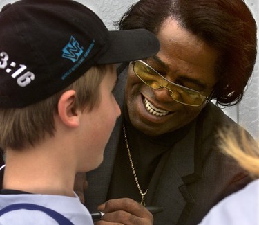 James Brown signs a kid's shirt backstage at Bluesfest. A new history of Bluesfest by Chris Cobb reveals that Brown was approachable, if incomprehensible. (Photo by Julie Oliver, Ottawa Citizen)