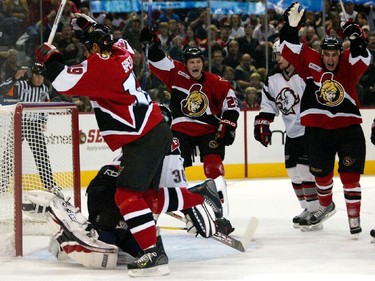 Jason Spezza of the Ottawa Senators celebrates his goal on goaltender Ryan Miller of the Buffalo Sabres asteamates Chris Neil and Brandon Bochenski look on during first period action held at the Corel Centre, Saturday, October 09, 2005.