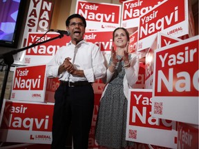 Ottawa-Centre Liberal incumbent Yasir Naqvi gives a speech beside his wife Christine McMillan at the Clocktower Brewpub in Westboro, in Ottawa, Ont., after being announced as the winner of his riding on June 12, 2014.