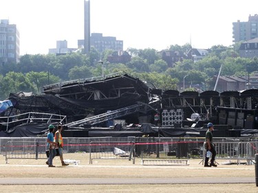 Workers at the scene of the collapsed MBNA stage (background) on the grounds of Bluesfest in Ottawa on Monday, July 18, 2011. Sunday evening around 7:20pm, the grounds were totally evacuated and all remaining concerts were cancelled after the stage collapsed. No serious injuries were reported, although some people were taken away by paramedics. Bluesfest stage collapse follow-up.