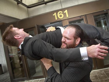 Devon Nicholson, a would-be pro wrestler, demonstrates his signature move the "Sacrifice Power Bomb" on lawyer Marc Sauve outside the Ottawa court house. Nicholson won his case, negligence, assault, etc. against  wrestler Abdullah the Butcher. Nicholson had a long battle getting over Hep-C, which he thinks he picked up from Abdullah the Butcher.