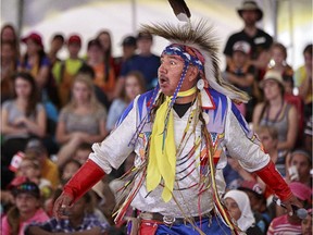 Melvin John performs for some of the 6,000 school children who arrived at Vincent Massey Park on Friday, June 19, 2014 to learn about Aboriginal culture and heritage.