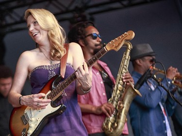 Susan Tedeschi, left, Derek Trucks, centre, and Maurice Brown of the Tedeschi Trucks band perform on the main stage at the 2014 Ottawa Jazz Festival.