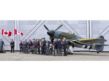 Veterans gather in front of a Typhon fighter bomber during 70th Anniversary of D-Day and the Battle of Normandy  commemorative event on June 6, 2014, at the Canada Aviation and Space Museum, in Ottawa.