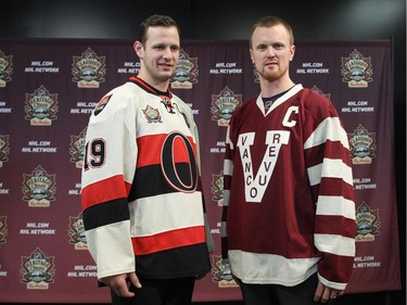 Jason Spezza (L) of the Ottawa Senators and Henrik Sedin (R) of the Vancouver Canucks unveil their respective classic jerseys, at Canadian Tire Centre, on November 28, 2013, in Ottawa, Ont. The Senators will wear their classic jersey during the NHL Heritage Classic game that will be played outdoors in Vancouver on March 2nd, 2014.
