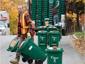 Nick Leonard delivers green bins along Fairmont Avenue on October 29, 2009, as the City Of Ottawa's Green Bin Program for household organics such as potato peelings continued to be rolled out across the region.