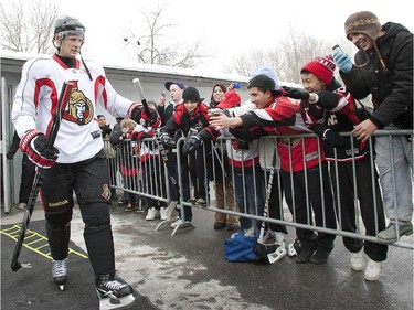 Jason Spezza touches outstretched hands as the Ottawa Senators took to the ice February 16, 2011, on an outdoor rink in Bayshore Park in west end Ottawa for a bit of fun and to reach out to local fans and inner city kids that may not get much of a chance to see the NHL players.