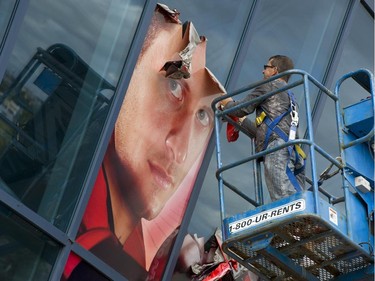 Jason Spezza has his face torn down from the Scotiabank Place facade at Gate 1 as the Ottawa Senators get ready to launch their 20th season since re-entering the league with a retrospective type presentation instead of "larger than life" photos of players that had been over the entrance.