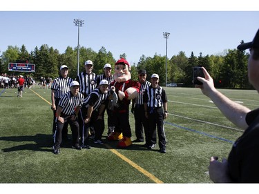 Ottawa RedBlacks mascot Big Joe poses for a picture with officials after an intrasquad game at the Mont-Bleu Sports Complex in Gatineau on Saturday, June 7, 2014.