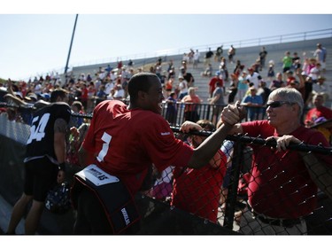 Ottawa RedBlacks Quarterback #1 Henry Burris greets fans after an intrasquad game at the Mont-Bleu Sports Complex in Gatineau on Saturday, June 7, 2014.