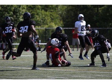 Ottawa RedBlacks' Quarterback Corey Leonard slides for a down during an intrasquad game at the Mont-Bleu Sports Complex in Gatineau on Saturday, June 7, 2014.