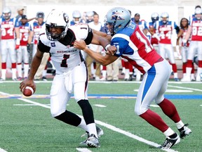 Chip Cox #11 of the Montreal Alouettes sacks Henry Burris #1 of the Ottawa Redblacks during the CFL game at Percival Molson Stadium on June 20, 2014 in Montreal.