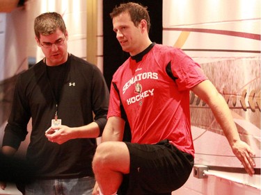 Jason Spezza stretches as he talks to a reporter. The first day of training camp for the 2009/2010 season consisted of testing and medicals for the for the Ottawa Senators players at Scotiabank Place in Ottawa on September 12, 2009