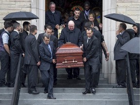 Pallbearers carry the casket of Brandon Volpi down the steps of St. Anthony's Church in Ottawa following his funeral on Friday, June 13, 2014.