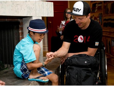 Para-Alpine skier Josh Dueck is shown how to thumb wrestle by Jeremy Kilabuk, 11, as Manoir Ronald McDonald House Ottawa welcomed Canadian Olympians and Paralympians to the House as part of the 2014 Celebration of Excellence for the athletes and the 30th anniversary of the House. Jeremy is currently staying at the Ronald McDonald House.