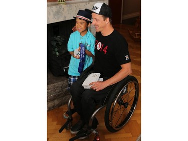 Para-Alpine skier Josh Dueck poses with Jeremy Kilabuk, 11, as Manoir Ronald McDonald House Ottawa welcomed Canadian Olympians and Paralympians to the House as part of the 2014 Celebration of Excellence for the athletes and the 30th anniversary of the House. Jeremy is currently staying at the Ronald McDonald House.