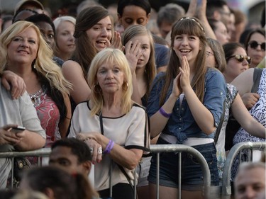 People clap as they wait for Aretha Franklin to arrive on the Main Stage at Confederation Park during the Ottawa Jazz Festival in Ottawa on Saturday, June 28, 2014.