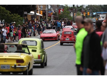 People take photos as italian made cars make their way along Preston St. in Ottawa's Little Italy, during Italian Festival on Saturday, June 14, 2014.