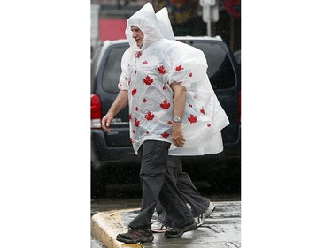 People were pulling out umbrellas, ponchos or running for cover as the rain came Tuesday (June 3, 2014) in the Byward Market, following record-high heat on Monday.  (Julie Oliver / Ottawa Citizen)