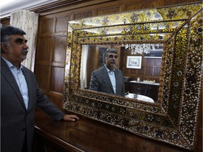 Peruvian Ambassador to Canada Jose Antonio Bellina stands with his favourite piece of art at his residence in Ottawa.
