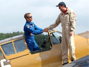 In a plane piloted by his brother, David (right), retired astronaut Chris Hadfield arrives at Gatineau Airport on Monday in a Second World War P-40 Kittyhawk.