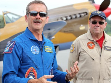 Piloted by his brother, David, right, retired astronaut Chris Hadfield arrived at Gatineau Airport Monday, June 30, 2014 in a Second World War P-40 Kittyhawk.