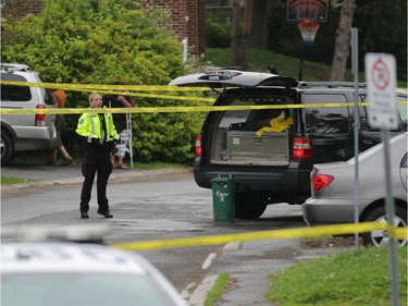 Police investigate a shooting in the 2800 block of Cedarwood Dr. near the Herongate Mall in Ottawa, Tuesday, June 17, 2014. One man is in hospital after being shot. Police say they are looking for a suspect. A pistol was recovered in a green bin (centre). Mike Carroccetto / Ottawa Citizen