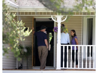 Police investigators talk to neighbours who live across the street (#173) from the scene of a fire and death at 170 Grey Fox Dr. in Corkery (Ottawa), Sunday, June 8, 2014.