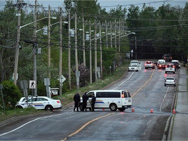 Police attend a roadblock on a street in Moncton, N.B. on Thursday, June 5, 2014. Three RCMP officers were killed and two injured by a gunman wearing military camouflage and wielding two guns on Wednesday. Police have identified a suspect as 24-year-old Justin Bourque of Moncton.