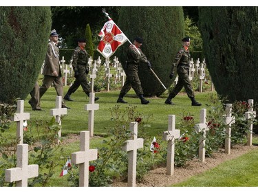 Polish soldiers arrive to participate in the French-Polish Commemoration D-Day Ceremony at the Polish cemetery in Urville-Langannerie, in Normandy, France, Friday,  June 6, 2014. World leaders and veterans gathered by the beaches of Normandy on Friday to mark the 70th anniversary of World War Two's D-Day landings.