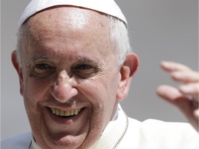 Pope Francis smiles as he waves to faithful at the end of his weekly general audience in St. Peter's Square at the Vatican, Wednesday, June 11, 2014.