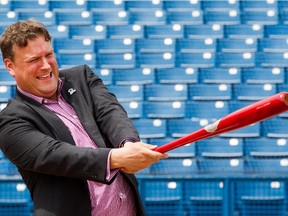 Ottawa Champions owner David Gourlay takes a swing of the bat.